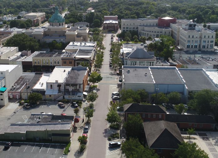 VIEW FROM ABOVE — This photo, taken with a drone, shows Indiana Avenue in Downtown DeLand, looking west. Many landmarks can be seen, including the Historic Volusia County Courthouse, Volusia County’s Thomas C. Kelly Administration Center, blocks of commercial buildings, and, of course, the historic Athens Theatre at the far end of Indiana AvenuePHOTO BY FLYING CAT DRONEWORKS/ANTHONY DeFEO