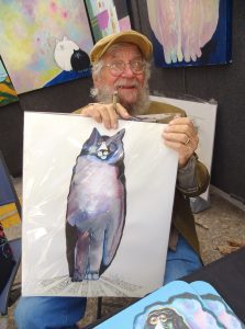 <p><p><strong>ARTS FESTIVAL REGULAR —</strong> Holding one of his iconic cats, artist Don Nedobeck greets visitors to the 2019 Fall Festival of the Arts in Downtown DeLand. Nedobeck’s wife, Liz, said Don was saddened by the news of the festival’s cancellation this year due to the COVID-19 pandemic.</p></p><p>BEACON PHOTO/MARSHA MCLAUGHLIN</p>