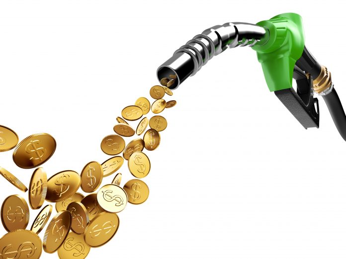 ADOBE STOCK IMAGE OF A GAS PUMP PUMPING GOLD COINS, REPRESENTING MONEY