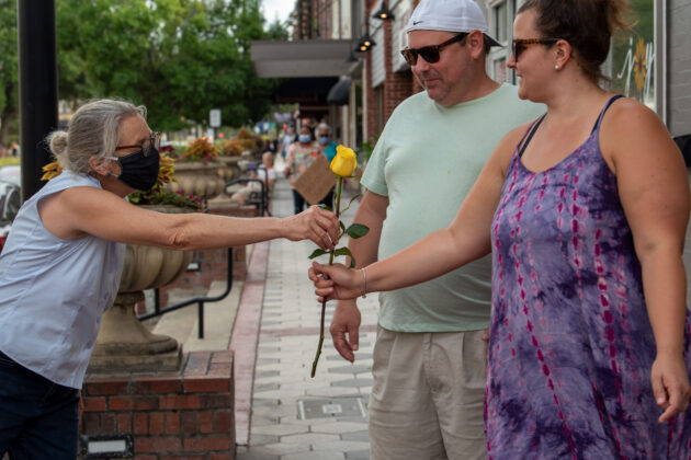 <p><p><em>The Beacon </em>publisher Barb Shepherd passes out roses to protestors June 2.</p></p><p>THE CANOVAS PHOTOGRAPHY</p>