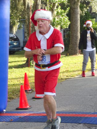 <p><p><strong>SANTA TO THE FINISH </strong>— Despite the demands of his Christmas responsibilities, even Santa took time Dec. 24 for the Lake Helen race. According to the race-results, Chuck McLaughlin placed 279th overall.</p></p><p>BEACON PHOTO/MARSHA MCLAUGHLIN</p>