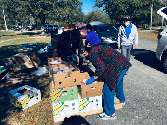 <p><p>A BEEHIVE OF ACTIVITY — Volunteers scramble to pick up and load a variety of food items into vehicles, with hundreds more cars waiting to move forward.</p></p><p></p>