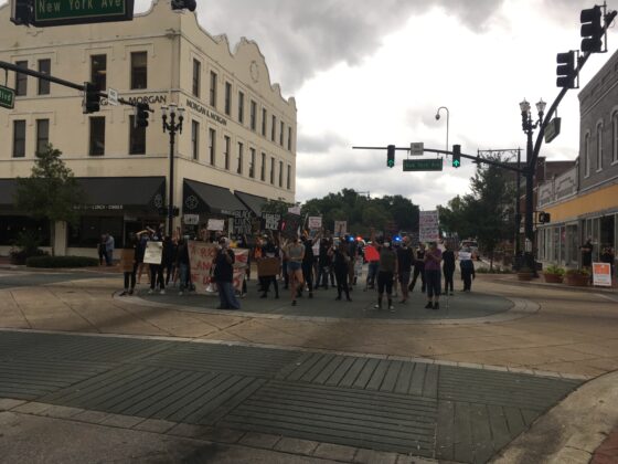 <p><p>About 1:30 p.m. Wednesday, a group of protesters stood in the middle of the intersection of Woodland Boulevard and New York Avenue in Downtown DeLand, blocking traffic in both directions and chanting, “No justice, no peace. Abolish police.”</p><p>The group also read out the names of people who have been victims of police violence.</p><p>Their efforts were supported by DeLand police, whose officers stopped traffic in both directions on the two highways to allow the protest to continue safely.</p><p>After about 15 minutes, the group marched north on Woodland Boulevard. The group appeared to disband by midafternoon.</p></p><p>BEACON PHOTO/BARB SHEPHERD</p>