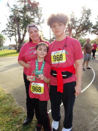 <p><p><strong>IN ON THE ACTION </strong>— Lake Helen City Commissioner Kelly Frasca congratulates her children, Giovanni Frasca and Joaquin Frasca, on cmpleting the Lake Helen Stress Buster 5K on Christmas Eve.</p></p><p>BEACON PHOTO/MARSHA MCLAUGHLIN</p>