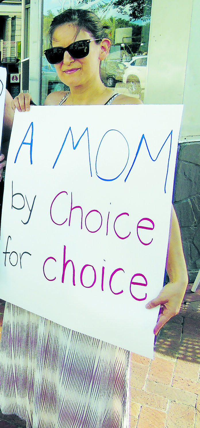 A mom holds her sign during an abortion-rights protest
